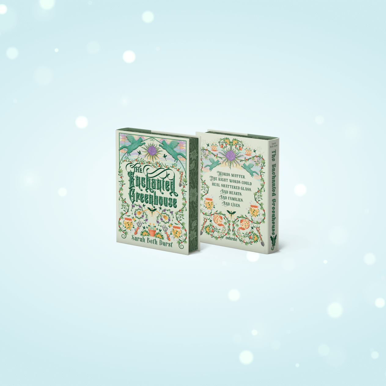 OwlCrate limited edition of The Enchanted Greenhouse. Front and back cover centered on a pale blue background, with ornamental vines framing the borders.