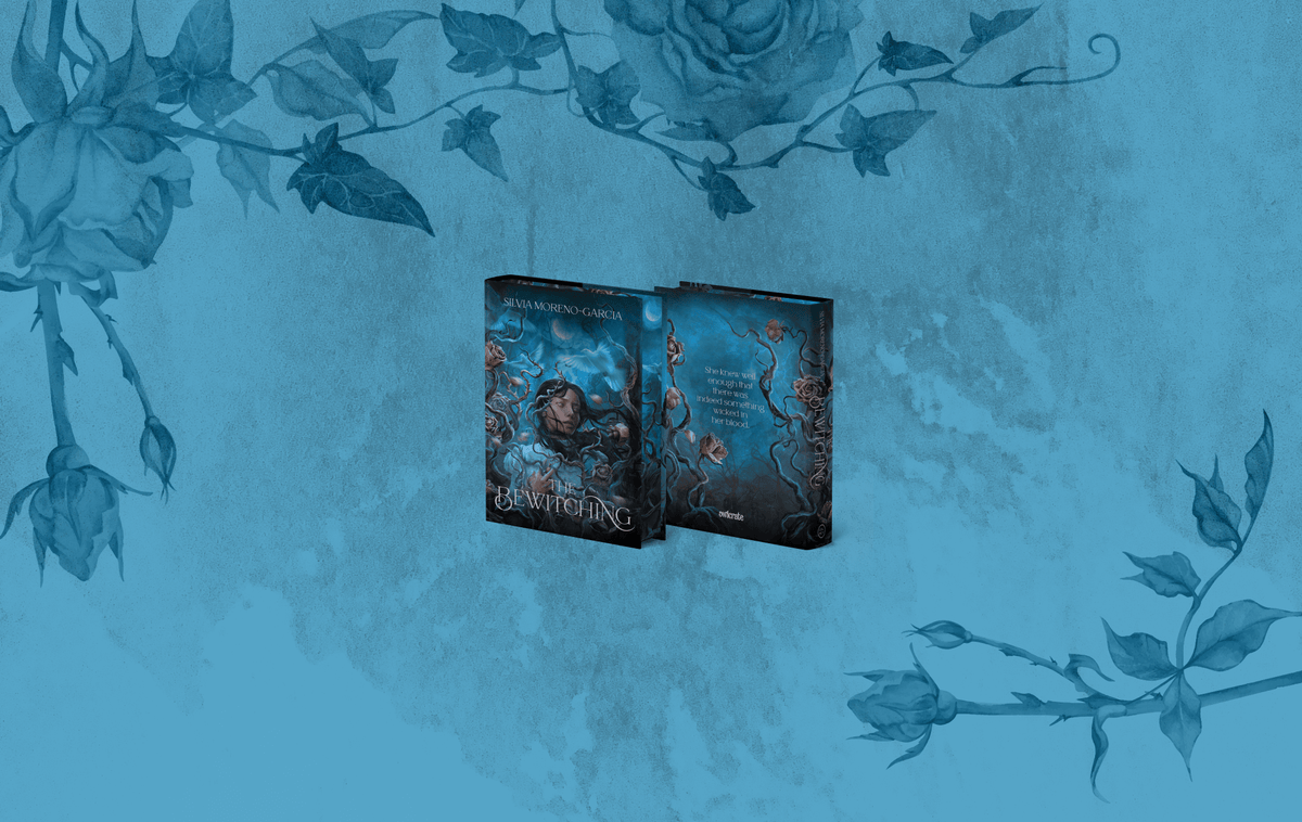 OwlCrate limited edition of The Bewitching. The front and back of the book are centered on a blue background with roses and vines framing the edges.