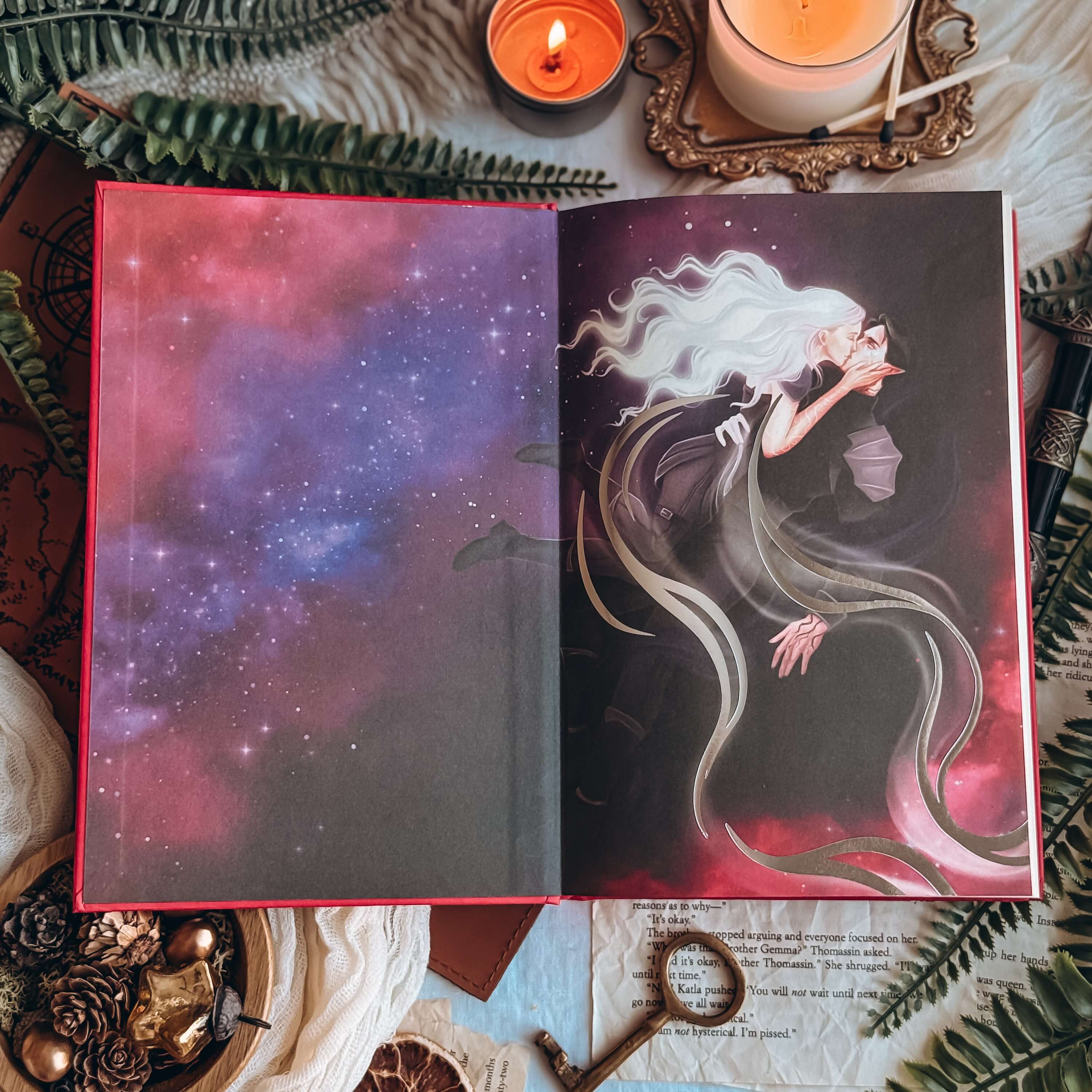 Opening endpaper of The Dark is Descending by Chloe C Peñaranda showing two people kissing, a woman with long flowing white hair and a dark-haired elven man, floating in space.