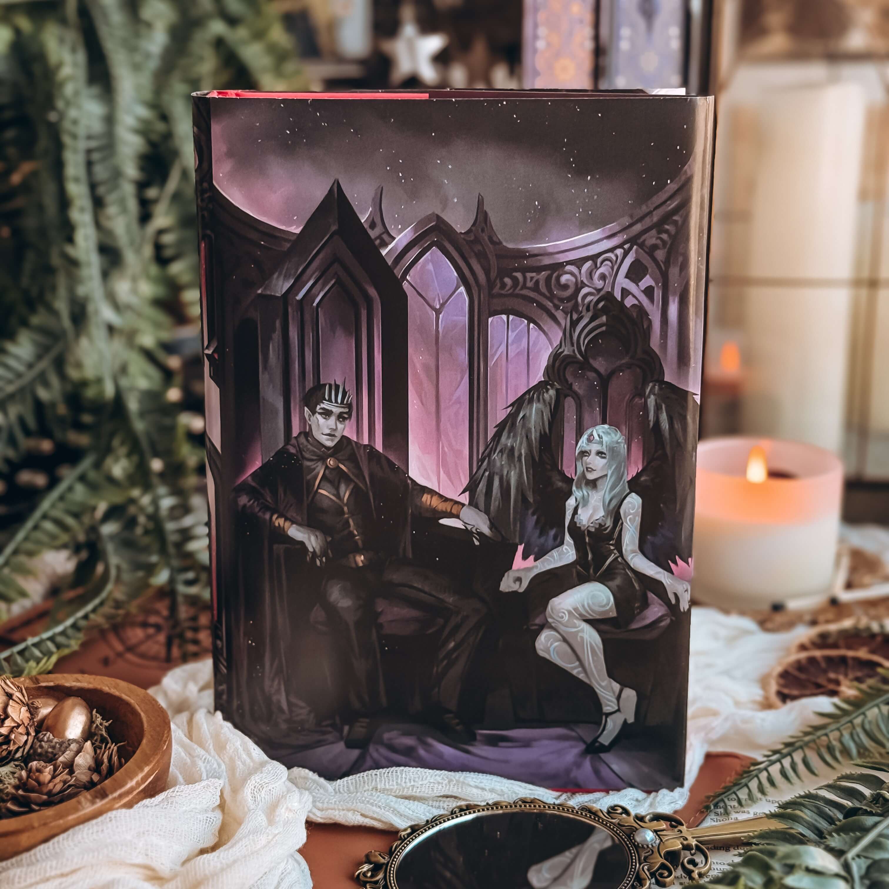 Reversible dust jacket for The Dark is Descending by Chloe C Peñaranda showing an illustration of two people sitting on their respective thrones in a dark, ornate setting. 