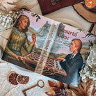 A flat-lay showing the reversible dust jacket for Immortal Game by Allison Saft surrounded by autumnal-themed decorative items. The dust jacket artwork shows an illustration featuring two characters, one in contemporary clothing and the other in fantasy clothing, playing chess.