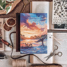 Back of Starter Villain by John Scalzi. Cover shows an illustrated tropical sunset, words reading Humans do a good job of making outcasts. Book is suurounded by decorative items. 