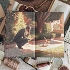 Opening endpaper for Starter Villain by John Scalzi. Illustrated scene of a man in a suit, crouched down and holding a cellphone to his ear, reaching out to a orange and white cat.  